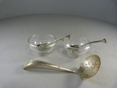 A pair of small glass bowls with continental silver teaspoons and a Silverplated sugar sifter