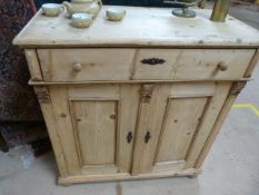 An Antique pine sideboard with two doors