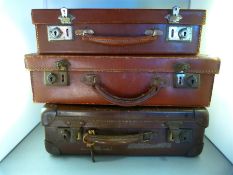 Three small vintage suitcases