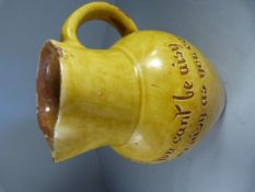 Fremington pottery jug by Edwin Beer Fishley with yellow glaze and the inscription ‘If you cant be