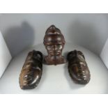 A Pair of Carved African Masks and a Terracotta Bust of a Tribal man signed to back