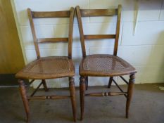 A Pair of cane seated dining chairs