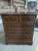 A small chest of mahogany drawers