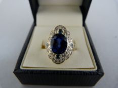 A Silver Ring set with an oval 10.10mmx8.5mm and four small Sapphire blue CZ stones with 28 small