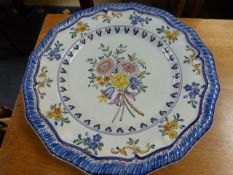 A large handpainted charger in the Delft style