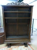 A Dark wood oak Bookcase - raised on two feet, with Lion Head finial
