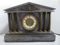 A Black marble clock with pillared front and enamelled dial