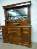 A Large Mahogany break front dresser with mirrored back