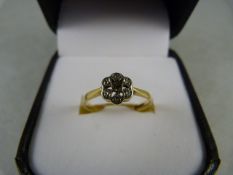 An 18ct Yellow Gold Diamond 'Daisy' Cluster Ring - small swiss cut centre stone with 6 diamond chips