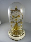 An Enamelled and Brass Koma mantle clock under glass dome