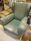 A Green wing back fireside armchair