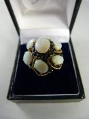 A 9ct Gold Ring with Opals and Sapphires - Centre Opal approx 9mm x 7.1mm with 6 approx 5mm x 7mm