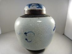 Oriental blue and white ginger jar, double blue circle mark to base, depicting an outdoor scene. H