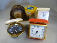 Five various travel clocks in cases