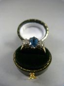 A 9ct Gold dress ring set with blue Topaz stone - stone approx 7.6mm x 6mm with two stones either