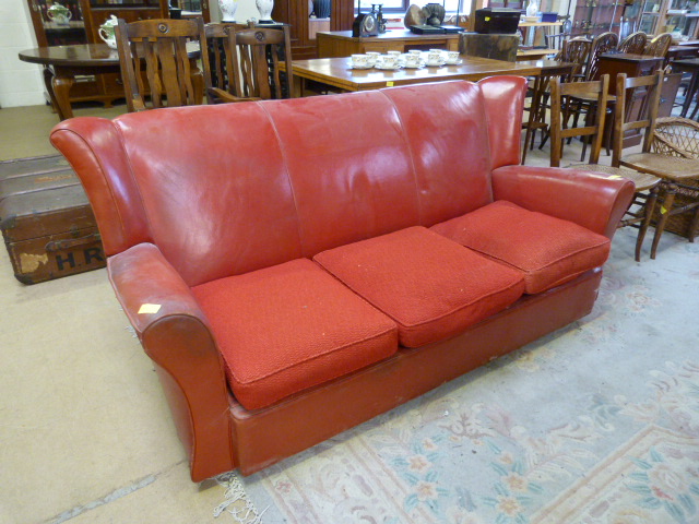 A Red Italian leather sofa with two matching armchairs