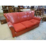 A Red Italian leather sofa with two matching armchairs