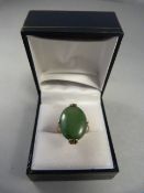 14ct gold jade ring, oval stone approx 17.5mm x 13mm. Oriental markings. Size L 1/2 UK, 5 3/4 USA