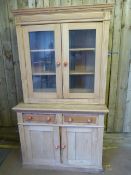 A Pine dresser with glazed cabinet over