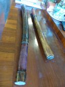 Two wooden truncheons /clubs possibly African with leather handles. Approx 80cm & 64cm.