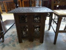 An oriental style folding table with removable top