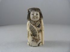 An oriental carved figure of a girl in the form of a pendant possibly ivory - with hand painted