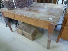 An antique pine kitchen table with single drawer