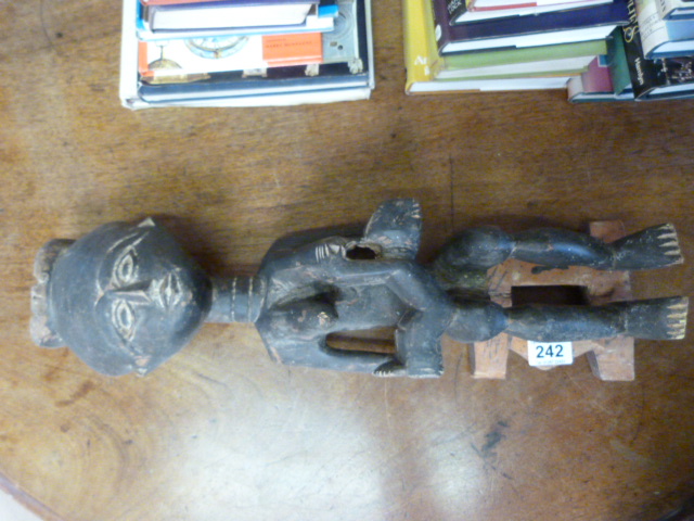 An African carved wooden figure of a mother and her baby - height 53cm