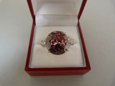 A Silver Ring, Large, 15.10mm diameter Brilliant cut Pink CZ with a small White CZ on each