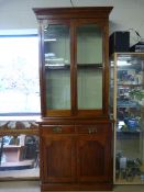 A Small mahogany dresser with glass cabinet over