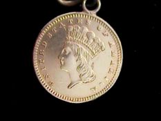 A Gold 1 dollar coin 1889 designer James B. Longacre and fineness 0.9000. With gold coloured pin