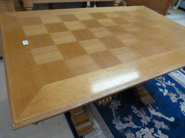 Parquet top rectangular table on heavily carved legs