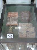 Display case containing Arsenal Football club memorabilia - studs, Trophy, Ball, Whistle etc