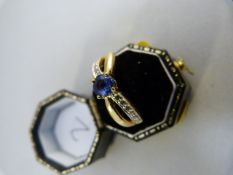 18ct Gold ring set with sapphire and diamonds on Arc mount
