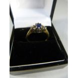 9ct Sapphire and Diamond ring with pale blue (Ceylon) Sapphire with three diamonds either side