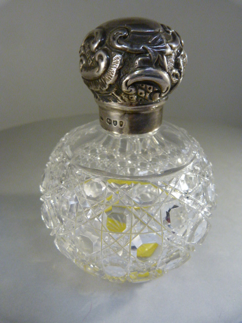 Cut glass scent bottle with original stopper and Hallmarked silver lid