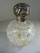 Cut glass scent bottle with original stopper and Hallmarked silver lid