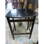 An Ebonised occasional table