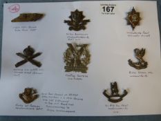 Various cap badges to include a Rare 1st issue of the Newfoundland Badge