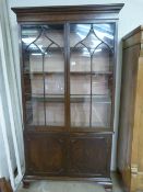 Three shelved lined mahogany cupboard with bookcase over