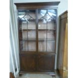 Three shelved lined mahogany cupboard with bookcase over