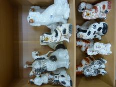 Collection of Stafforshire dogs and a Flatback - 2 shelves