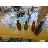 A quantity of glass bottles of varying sizes