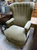 Green upholstered wingback armchair