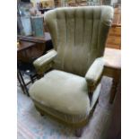 Green upholstered wingback armchair
