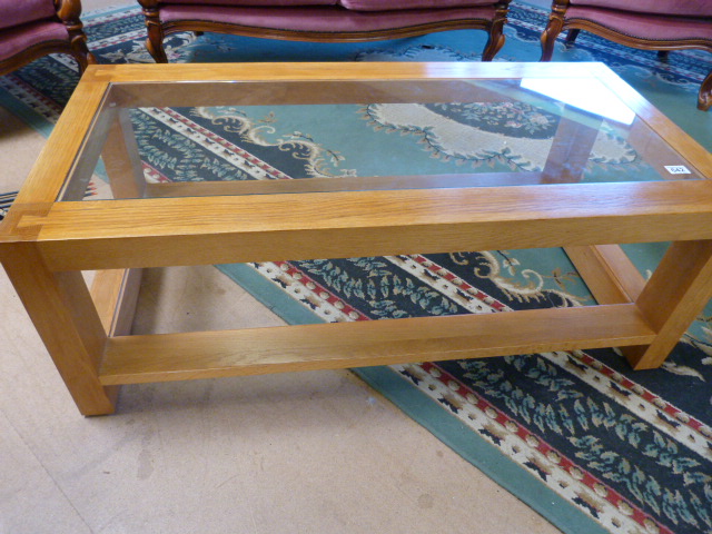 An oak glass topped coffee table