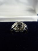 9ct white gold cluster ring with central possibly black diamond. Surrounded by 10 small white