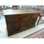 An oak sideboard with two cupboards and three drawers over