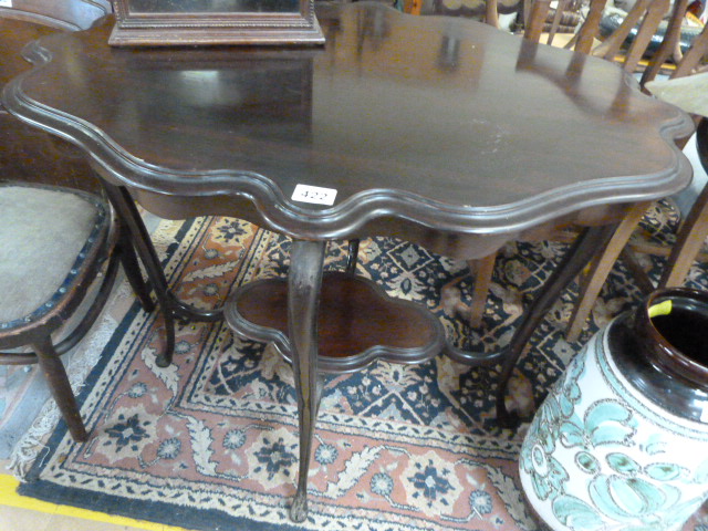 An unsual mahogany shaped two tier occasional table