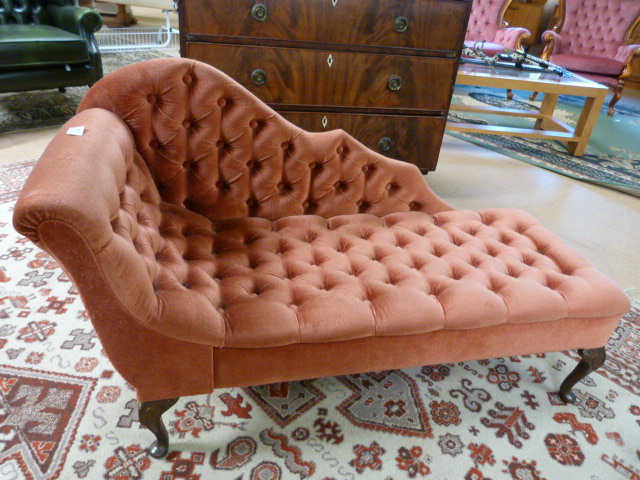 Miniature pink upholstered button back chaise longue on carved legs